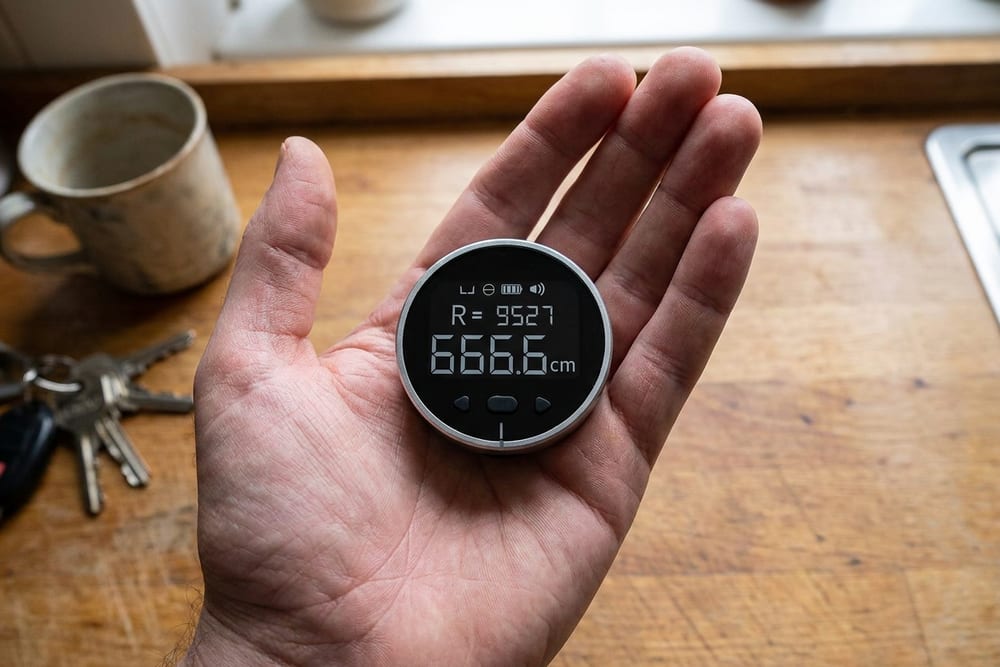 The pocket-size round ruler resting in the palm of a hand